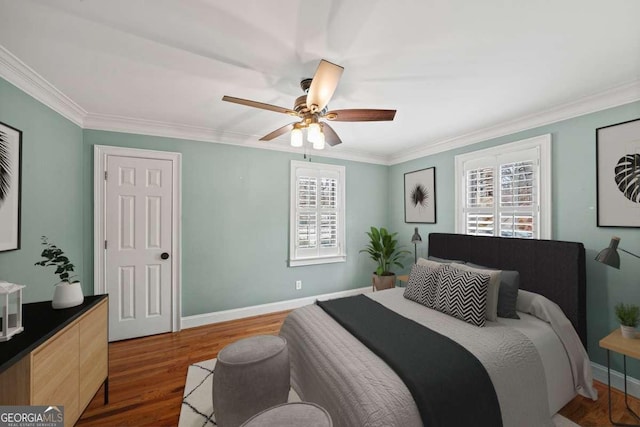 bedroom with crown molding, dark hardwood / wood-style flooring, and multiple windows