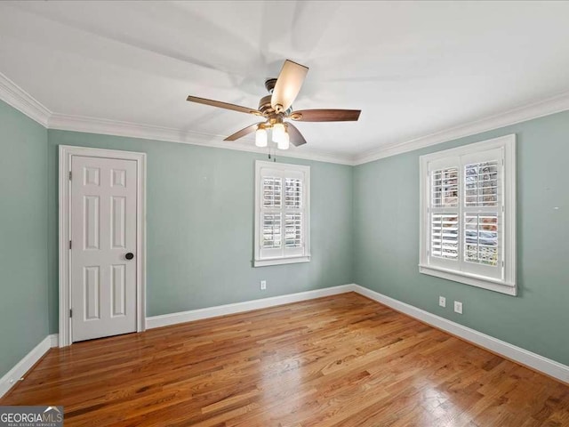 empty room featuring crown molding, ceiling fan, and light wood-type flooring