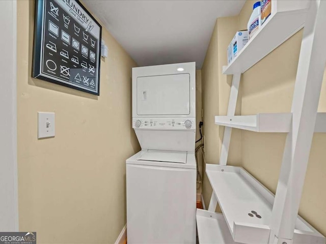 washroom featuring stacked washer and dryer