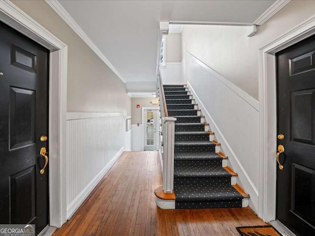 foyer featuring hardwood / wood-style flooring and ornamental molding