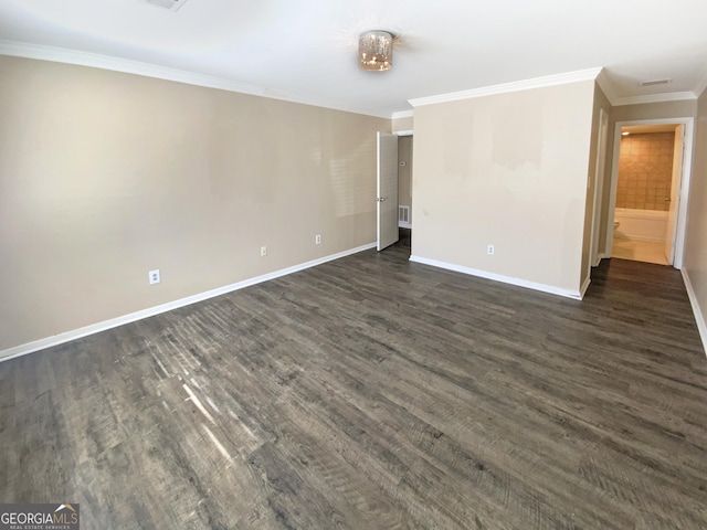 spare room featuring ornamental molding and dark hardwood / wood-style flooring