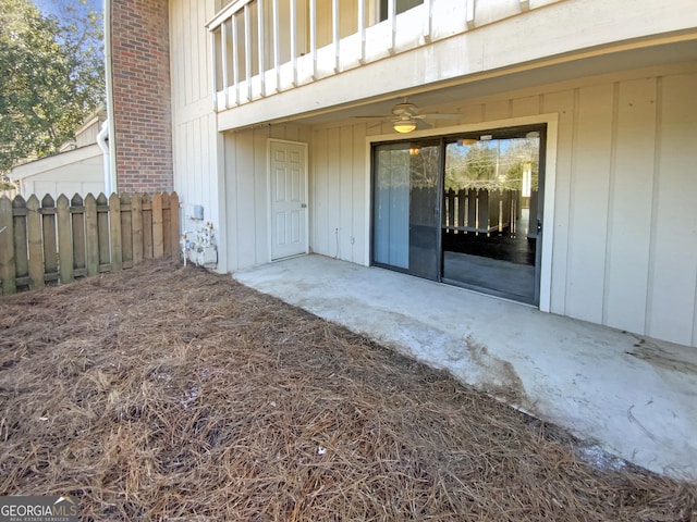 entrance to property with ceiling fan, a patio area, and a balcony