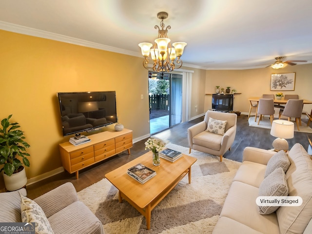 living room featuring crown molding, hardwood / wood-style flooring, and ceiling fan with notable chandelier