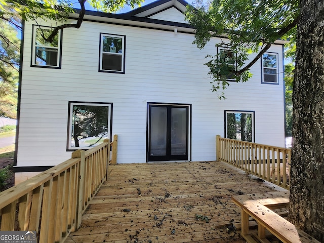 back of property with a wooden deck