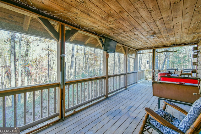 sunroom with pool table, wooden ceiling, and a healthy amount of sunlight