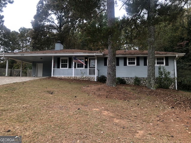 5250 Hollyhock Rd, Douglasville, GA 30135 - ranch-style home with a porch, a carport, concrete driveway, and a chimney