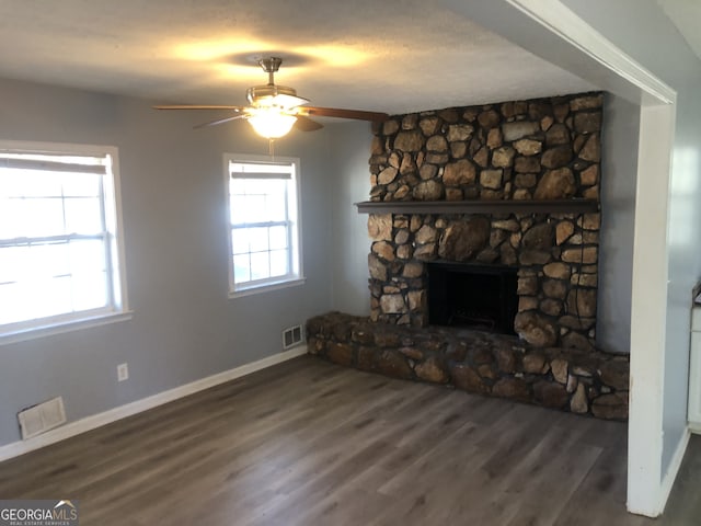 5250 Hollyhock Rd, Douglasville, GA 30135 - unfurnished living room with baseboards, wood finished floors, a ceiling fan, and a stone fireplace