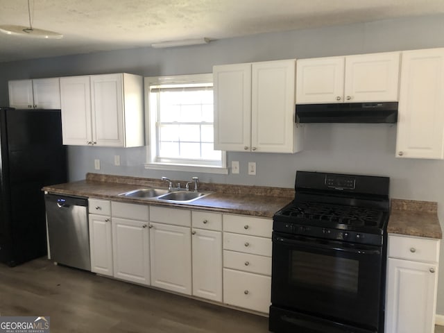 5250 Hollyhock Rd, Douglasville, GA 30135 - kitchen featuring black appliances, under cabinet range hood, a sink, dark wood-style flooring, and dark countertops