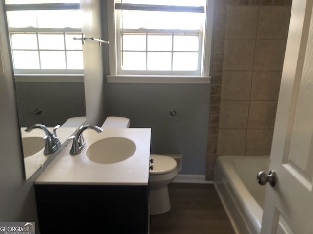 5250 Hollyhock Rd, Douglasville, GA 30135 - full bath featuring toilet, vanity, wood finished floors, and baseboards