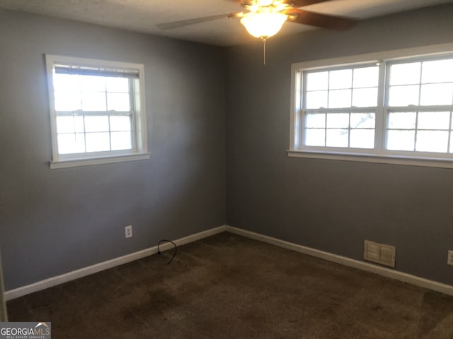 5250 Hollyhock Rd, Douglasville, GA 30135 - unfurnished room featuring ceiling fan, dark carpet, and baseboards