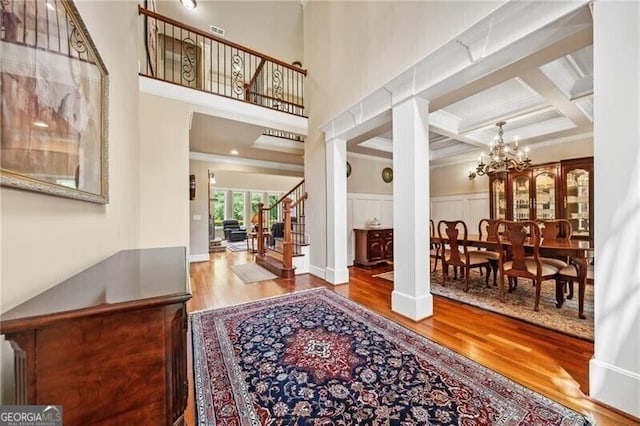 102 Townsend Pass, Alpharetta, GA 30004 - entryway with wood finished floors, a chandelier, stairway, coffered ceiling, and beam ceiling