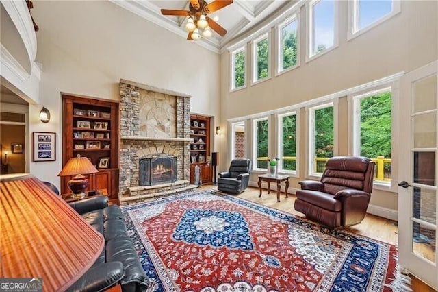 102 Townsend Pass, Alpharetta, GA 30004 - living area featuring a towering ceiling, a fireplace, a ceiling fan, crown molding, and coffered ceiling