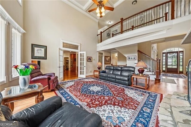 102 Townsend Pass, Alpharetta, GA 30004 - living area with french doors, a high ceiling, wood finished floors, crown molding, and stairway