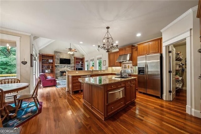 102 Townsend Pass, Alpharetta, GA 30004 - kitchen with stainless steel appliances, under cabinet range hood, open floor plan, a chandelier, and a fireplace