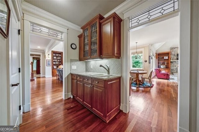 102 Townsend Pass, Alpharetta, GA 30004 - bar area featuring a sink, dark wood-style floors, decorative backsplash, crown molding, and baseboards