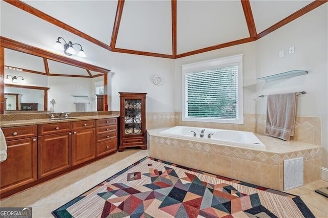 bathroom featuring vanity, tile patterned floors, and tiled bath