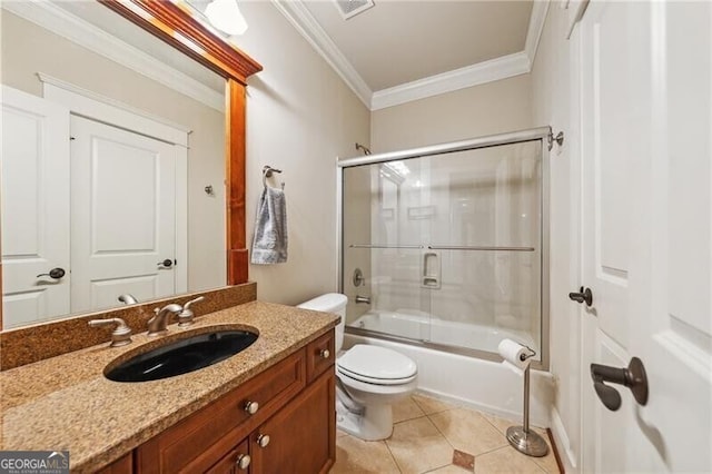 full bathroom with toilet, crown molding, bath / shower combo with glass door, vanity, and tile patterned flooring