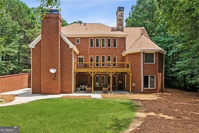 102 Townsend Pass, Alpharetta, GA 30004 - back of property with a chimney, a patio area, a lawn, and a wooden deck