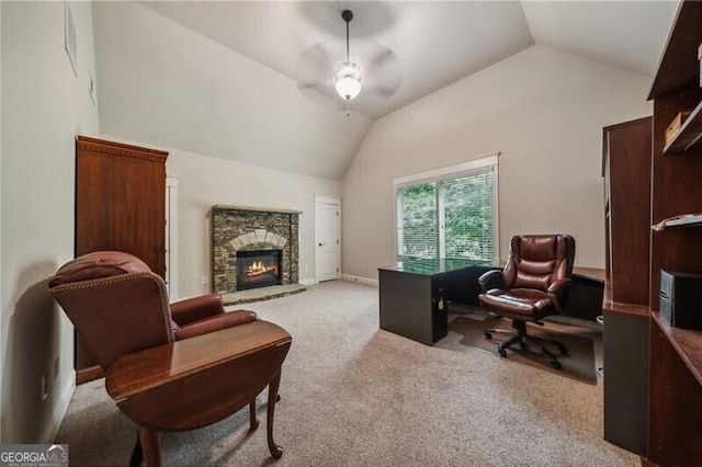 carpeted office featuring ceiling fan, lofted ceiling, and a fireplace