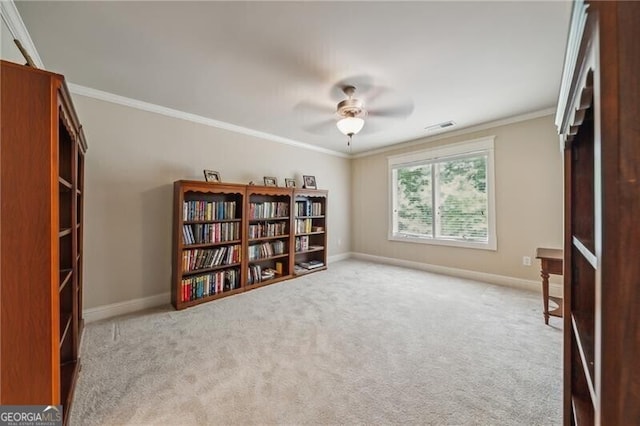 interior space featuring light carpet, ornamental molding, and ceiling fan