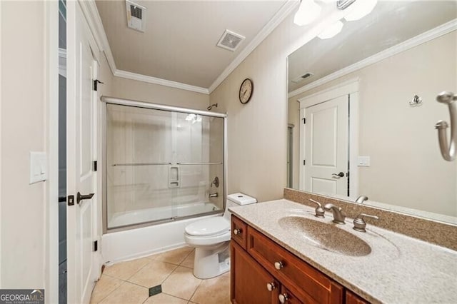 full bathroom with crown molding, tile patterned flooring, bath / shower combo with glass door, vanity, and toilet