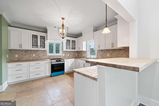 kitchen featuring stainless steel stove, white cabinets, hanging light fixtures, ornamental molding, and kitchen peninsula