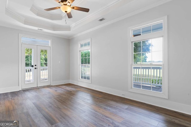 spare room with dark wood-type flooring, ornamental molding, a raised ceiling, and french doors