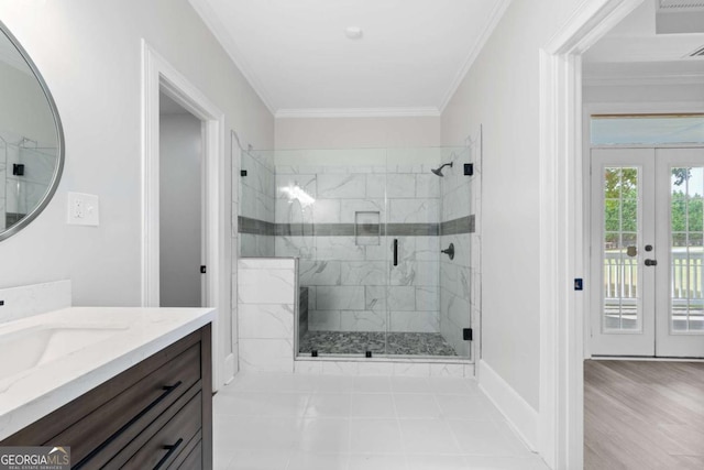 bathroom with vanity, crown molding, a shower with shower door, and french doors