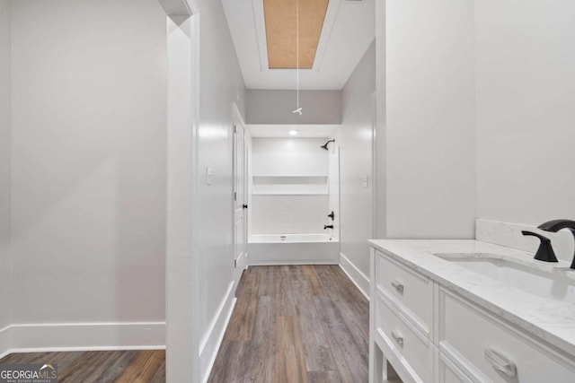 bathroom with wood-type flooring, bathing tub / shower combination, and vanity