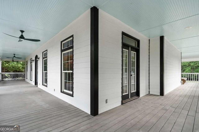 wooden terrace featuring ceiling fan and covered porch