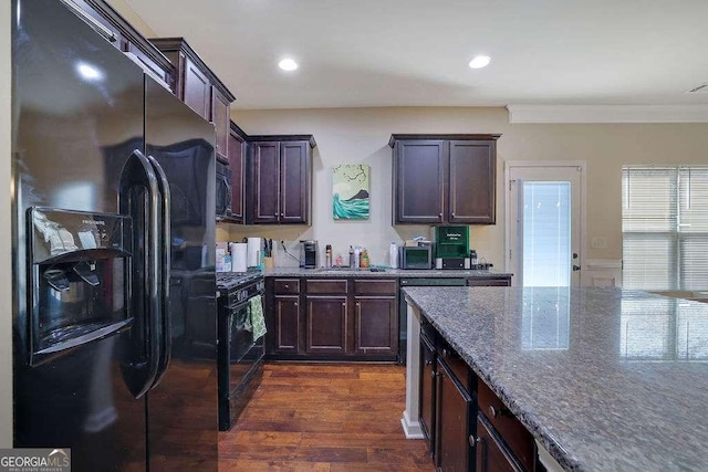 kitchen featuring dark stone counters, dark hardwood / wood-style floors, dark brown cabinets, and black appliances