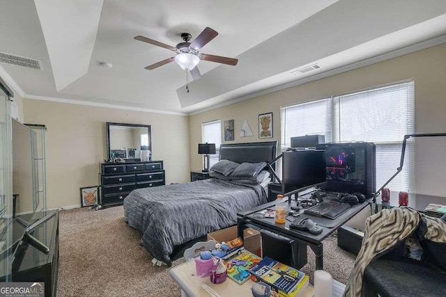 carpeted bedroom with crown molding, a raised ceiling, and ceiling fan