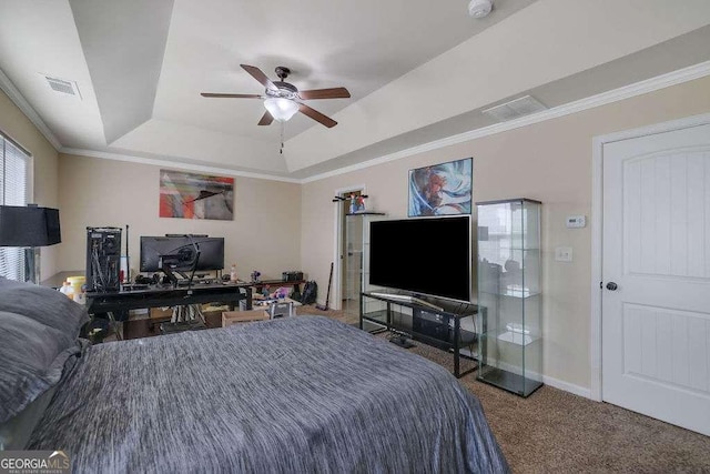 bedroom featuring crown molding, a raised ceiling, and dark carpet