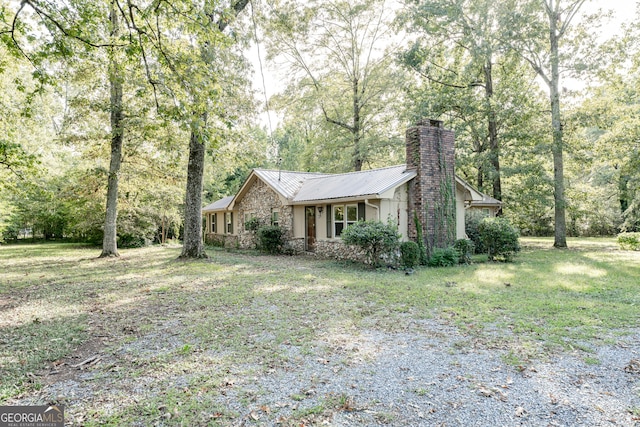 view of side of home with a lawn