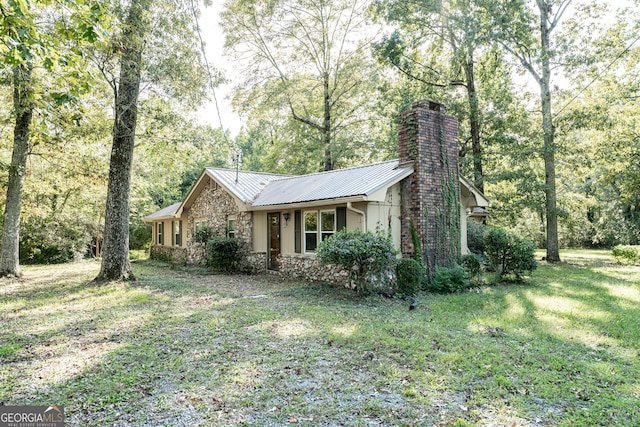 view of side of home featuring a lawn