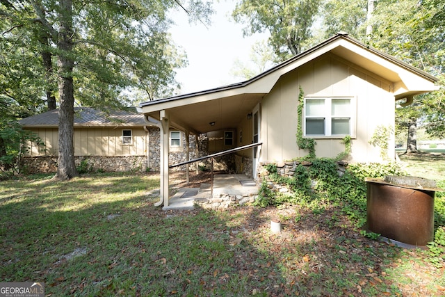 back of property featuring a yard