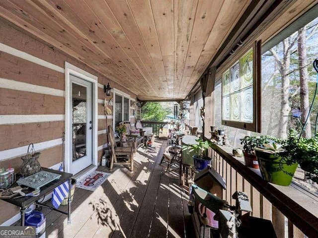 sunroom / solarium featuring wooden ceiling