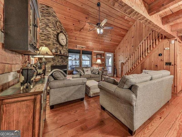 living room with a fireplace, wood-type flooring, wooden walls, and wooden ceiling