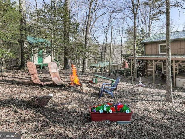 view of yard with an outdoor fire pit