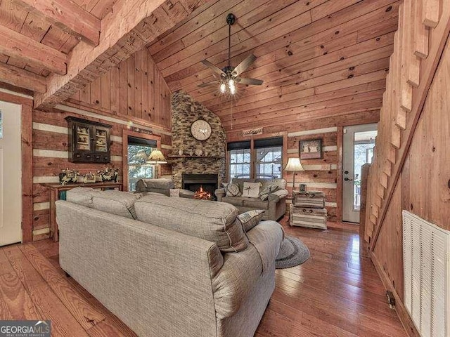 living room featuring wood-type flooring, a healthy amount of sunlight, wood ceiling, and a fireplace