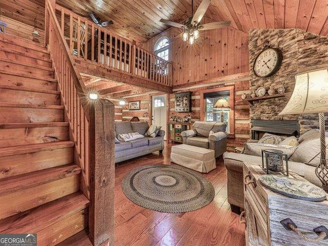 living room featuring high vaulted ceiling, wood-type flooring, wooden ceiling, and ceiling fan