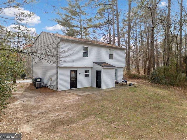 back of property with a patio area and a lawn