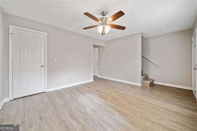 spare room with wood-type flooring and ceiling fan