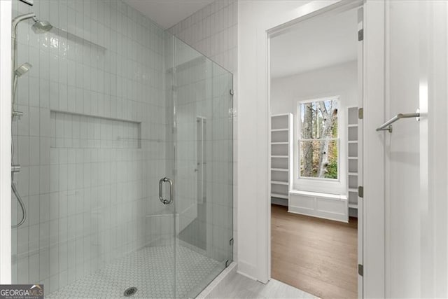 bathroom featuring walk in shower and hardwood / wood-style flooring