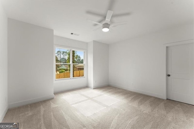 carpeted spare room with ceiling fan