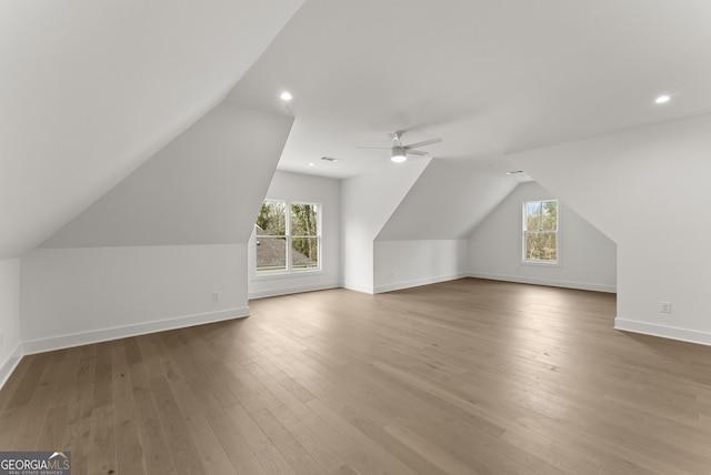 additional living space featuring lofted ceiling, recessed lighting, light wood-style flooring, ceiling fan, and baseboards