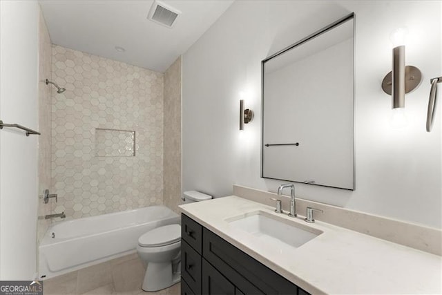 full bathroom with vanity, tile patterned flooring, tiled shower / bath combo, and toilet