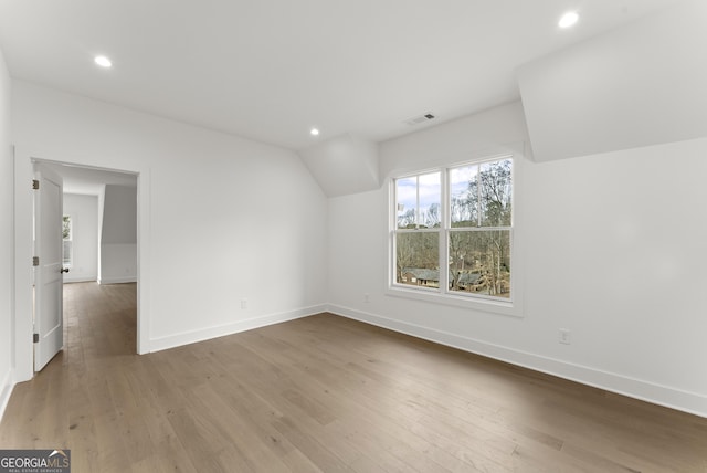 interior space with baseboards, wood finished floors, visible vents, and recessed lighting