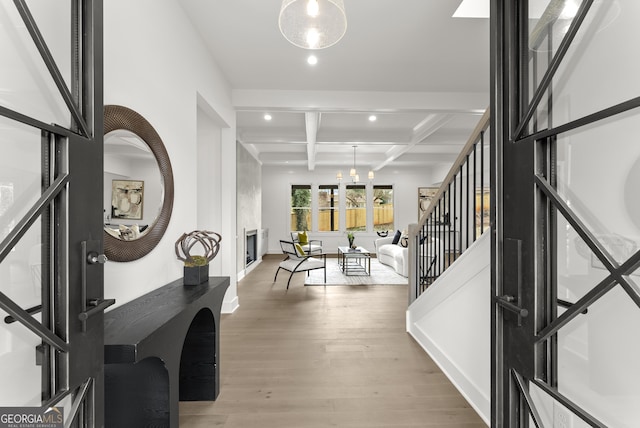 entryway with beam ceiling, recessed lighting, stairway, wood finished floors, and coffered ceiling