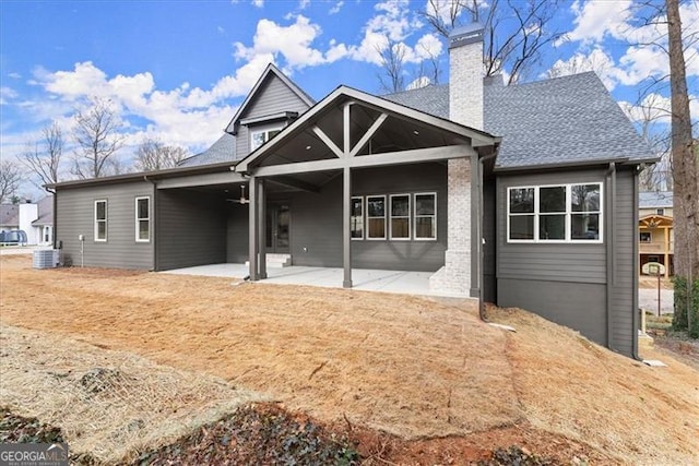 back of property with central air condition unit and a patio area